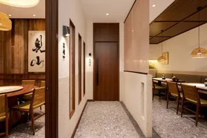 A dimly lit hallway with a wooden door and floor, featuring a simple and functional design