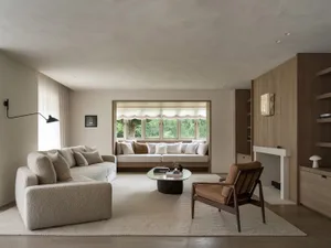Cozy living room with a brown couch, a chair, a coffee table, and a fireplace, creating a warm and inviting atmosphere