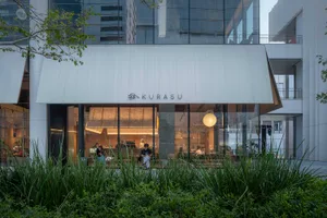 modern restaurant with natural light, wood, and metal elements, filled with people and furniture