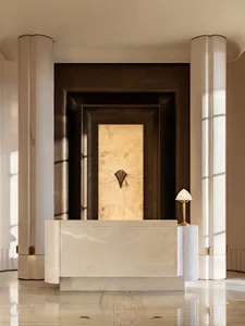 A modern bathroom with a white marble countertop, a gold lamp, and a sink and mirror, creating a luxurious and elegant space