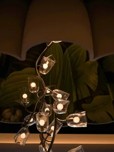 Cozy modern living room with a glass light fixture, a couch, and a chair, lit by dim overhead lighting