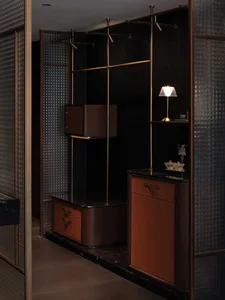 A modern bedroom with a brown color scheme, featuring a brown cabinet, dresser, and table, with a lamp and vase on the table, and a bed in the background