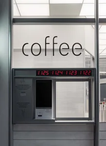 A modern coffee shop with a central coffee machine, surrounded by a wall with a window, creating an inviting atmosphere