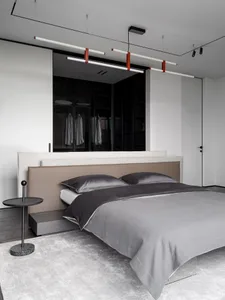 Cozy bedroom with a bed, nightstand, and dresser in a grey color scheme, with dim lighting and wood and fabric materials