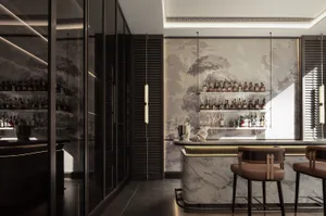 A well-lit bar area with a modern design, featuring a marble countertop, chairs, and a selection of bottles