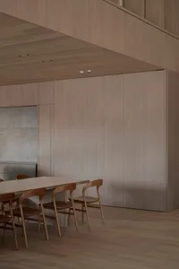 Dining room with wooden walls and table, wooden chairs, and a warm inviting atmosphere