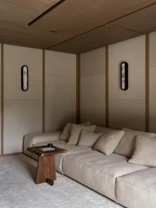 A well-lit living room with a couch, coffee table, and wooden floor, creating a bright and inviting atmosphere
