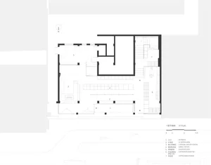 Black and white floor plan of a large room with a spiral staircase, furniture, and linework
