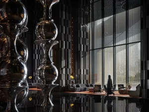 Bright and welcoming lobby with glass facade, natural light, and modern furniture