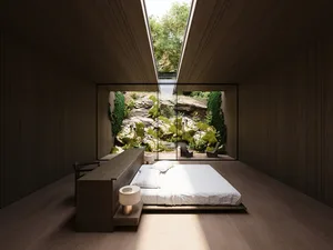 A well-lit bedroom with a wooden floor, a wooden desk, and a bed positioned near a window