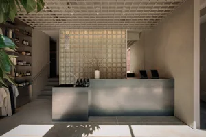 Bright and inviting living space with a stainless steel counter, dining table, and natural light