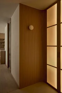 Cozy kitchen with wooden walls, a wooden door, and dim lighting