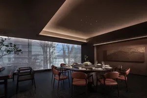 Cozy dining room with a wooden table, dim lighting, and elegant decor