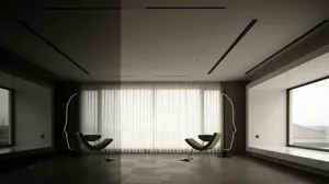 A black and white photograph of a minimalist living room with a chair and couch positioned in front of a large window