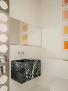 Bright and inviting bathroom with a modern sink, mirror, and marble countertop, featuring clean lines and minimalistic design
