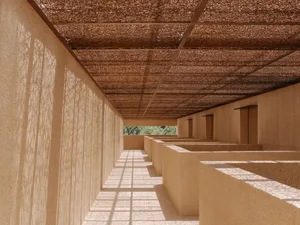 A bright and inviting hallway with a row of rooms, including a kitchen and dining area, lined with wood and stone materials