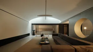 Comfortable living room with a large couch, coffee table, and chair, set against a brown background with a rug and well-lit atmosphere