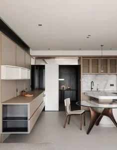 Cozy kitchen dining area with a glass table, wood accents, and dim lighting