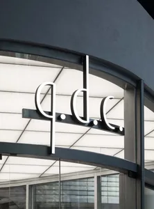 A modern building with a large glass window displaying a sign reading 'ddc' in a bright and inviting atmosphere