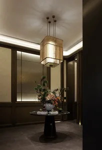 A dining room with a chandelier, a dining table, and a potted plant, with a combination of natural and artificial lighting