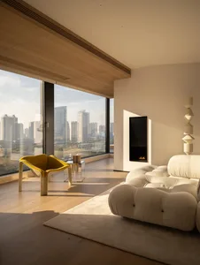 Cozy modern living room with a white couch, chair, and fireplace, lit by natural light from a large window with a city view