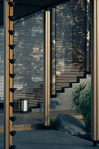 A calm and inviting outdoor scene featuring a wooden staircase leading to a doorway with natural lighting