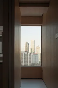 A bustling cityscape with glass and steel skyscrapers, illuminated by natural light, showcasing the urban landscape and energy of the city