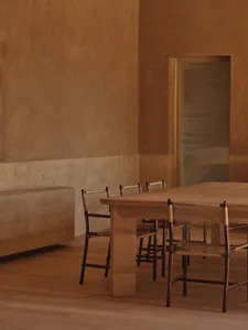 Cozy dining room with a wooden table and chairs, surrounded by a couch and dimly lit