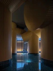 A well-lit pool area surrounded by wooden walls, creating a warm and inviting atmosphere for relaxation