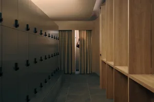 Dimly lit hallway with a door and a window, featuring a minimalist and functional design