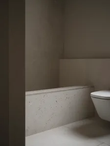 一間現代化的浴室，白色馬桶和洗手池，白色馬賽克牆，光亮的氛圍