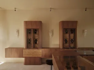 A store display featuring a wooden counter with a variety of jewelry on display, showcasing elegance and sophistication