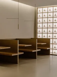A modern restaurant with a large dining area featuring wooden tables and metal chairs, well-lit and inviting