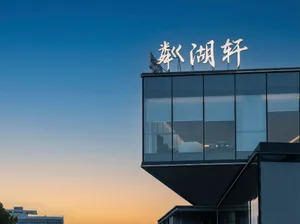 A modern building with a large glass wall and natural light pouring in, creating a sophisticated and elegant atmosphere