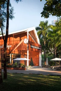 Casual outdoor restaurant with a patio area, wooden furniture, and metal accents, surrounded by a warm and inviting atmosphere