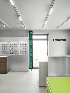 一間潔淨且組織良好的展售廳，牆壁和地板掛著鐘錶，整體採用白色風格
