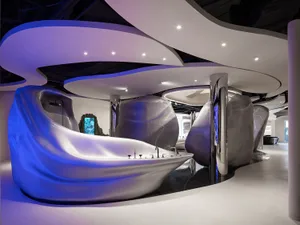 Sleek modern bathroom with a large curved bathtub, sink, and shower in a dimly lit space