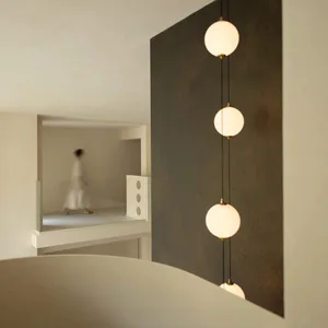A dimly lit living room or hallway with a woman in a white dress, black and white color scheme, and modern minimalist style