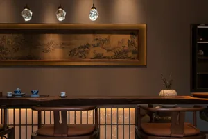 A warm and inviting dining area with a wooden table and chairs, surrounded by soft and diffused lighting