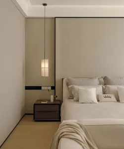 A modern bedroom with a bed, nightstand, and lamp, featuring a neutral color palette and white materials, giving the space a bright and airy feel