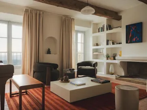 Cozy living room with a large window, modern furniture, and a rug, surrounded by books and natural light