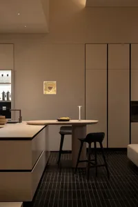 Warm and inviting kitchen with a wooden table, metal appliances, and natural light
