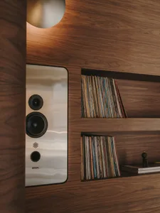 A cozy book-filled space with a wooden bookshelf and a variety of books arranged in a visually interesting display