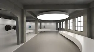 A large, empty lobby with a concrete floor, dimly lit, creating a moody atmosphere