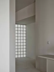 Small, minimalist room with a white wall and window, featuring a window sill