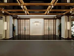 Bright and welcoming lobby with a large white wall, gold trim, and decorative elements, illuminated by natural light