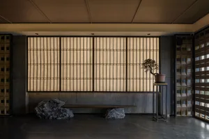 舒適的住宅空間，木地板、靠近大窗戶的長椅和桌子上的花瓶植物