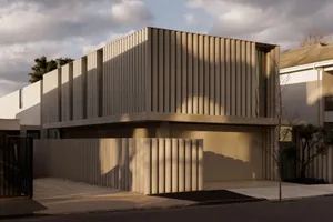Modern building with a concrete facade, vertical lines, and a sleek contemporary design