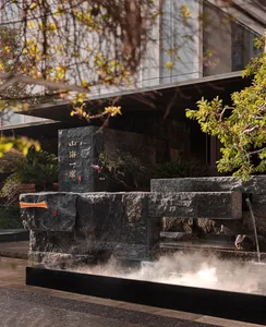 A serene stone building with a water feature in front, adding depth and visual interest