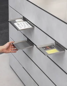 Dimly lit storage room with a gray cabinet and a gray floor, featuring a card in the cabinet drawer